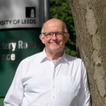 Profile photo of a man wearing a white shirt and glasses