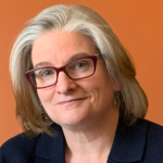 Profile photo of a woman wearing glasses and a suit blazer.