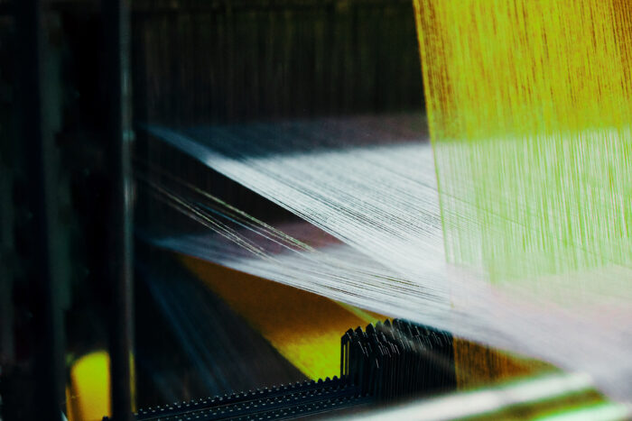 Image of sustainable textile threads being woven.